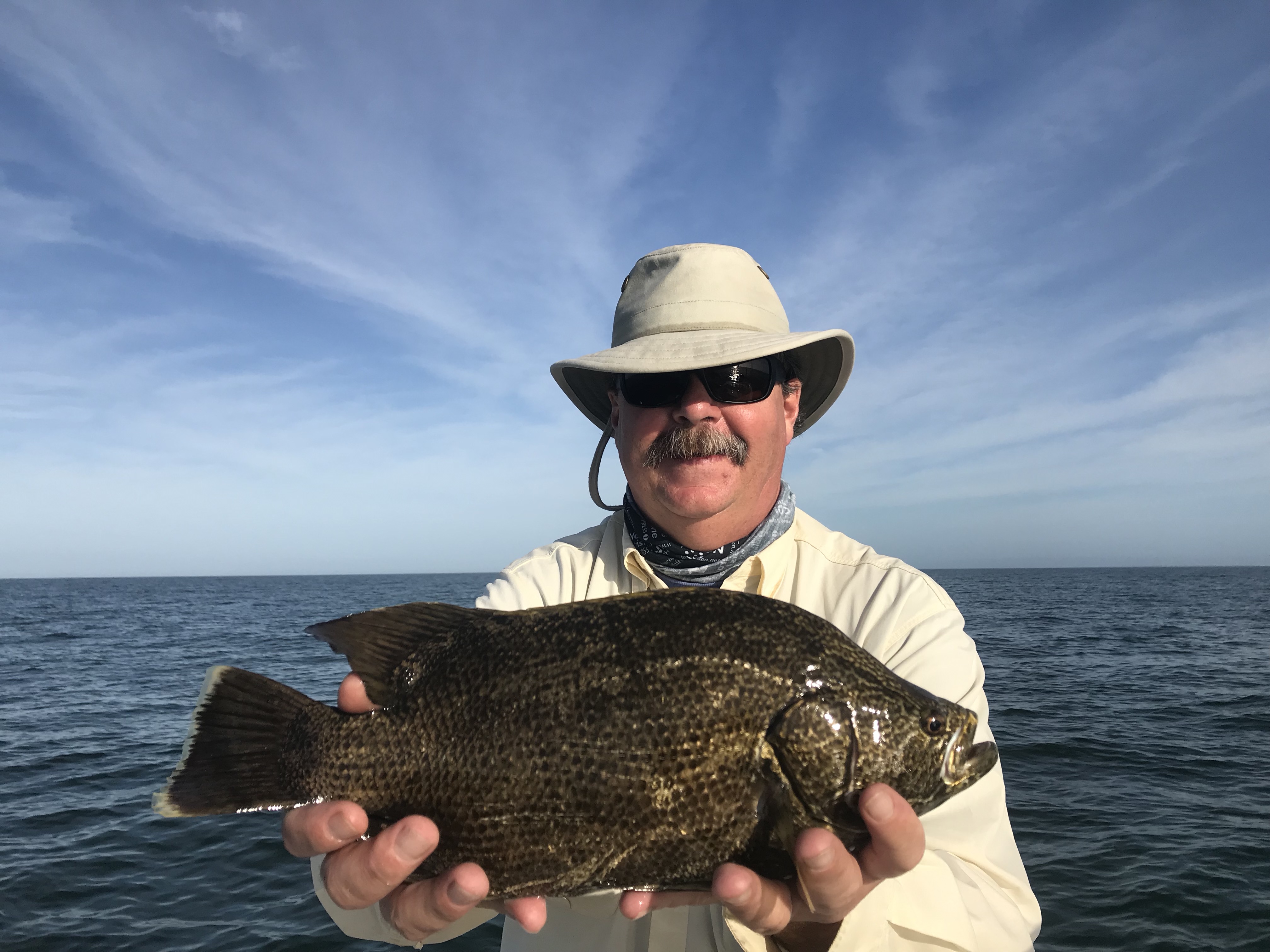 Bruce Knutson of Helena, Montana holding a Triple Tail fish
