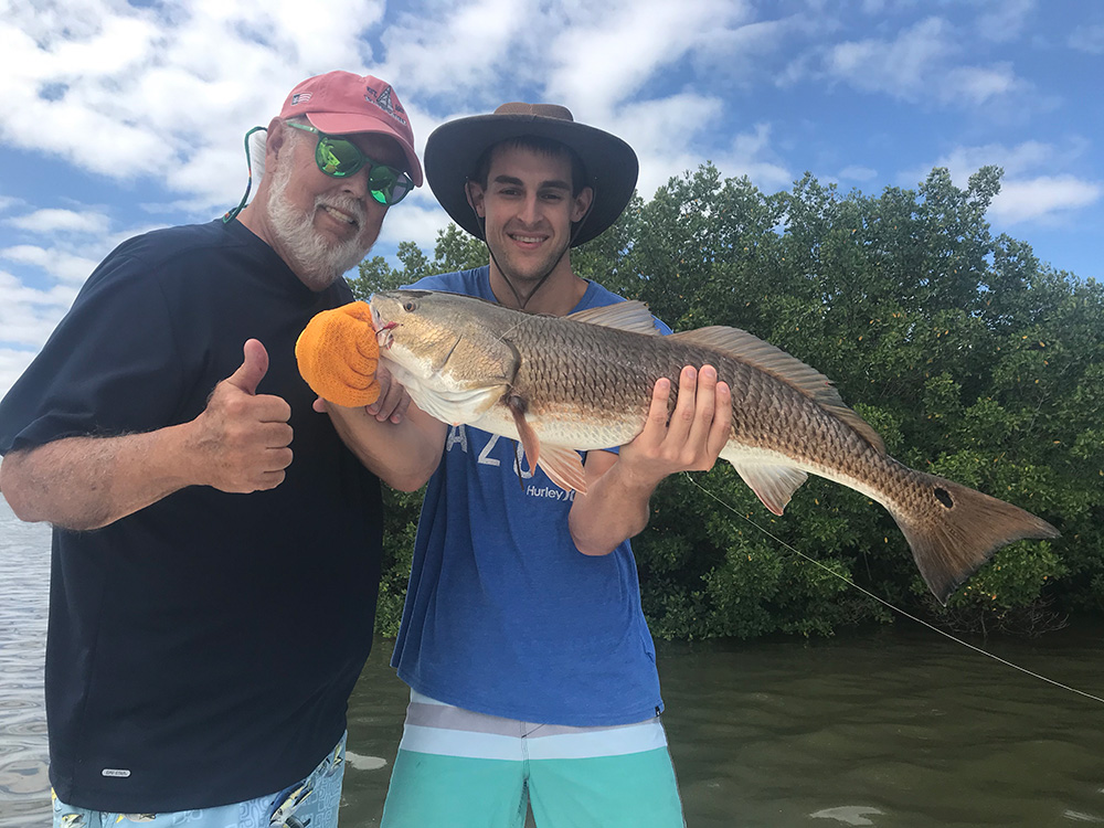 Captain Wayne Hasson and son Davis with Redfish catch