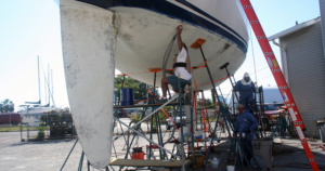 Sanding the bottom of a sail boat