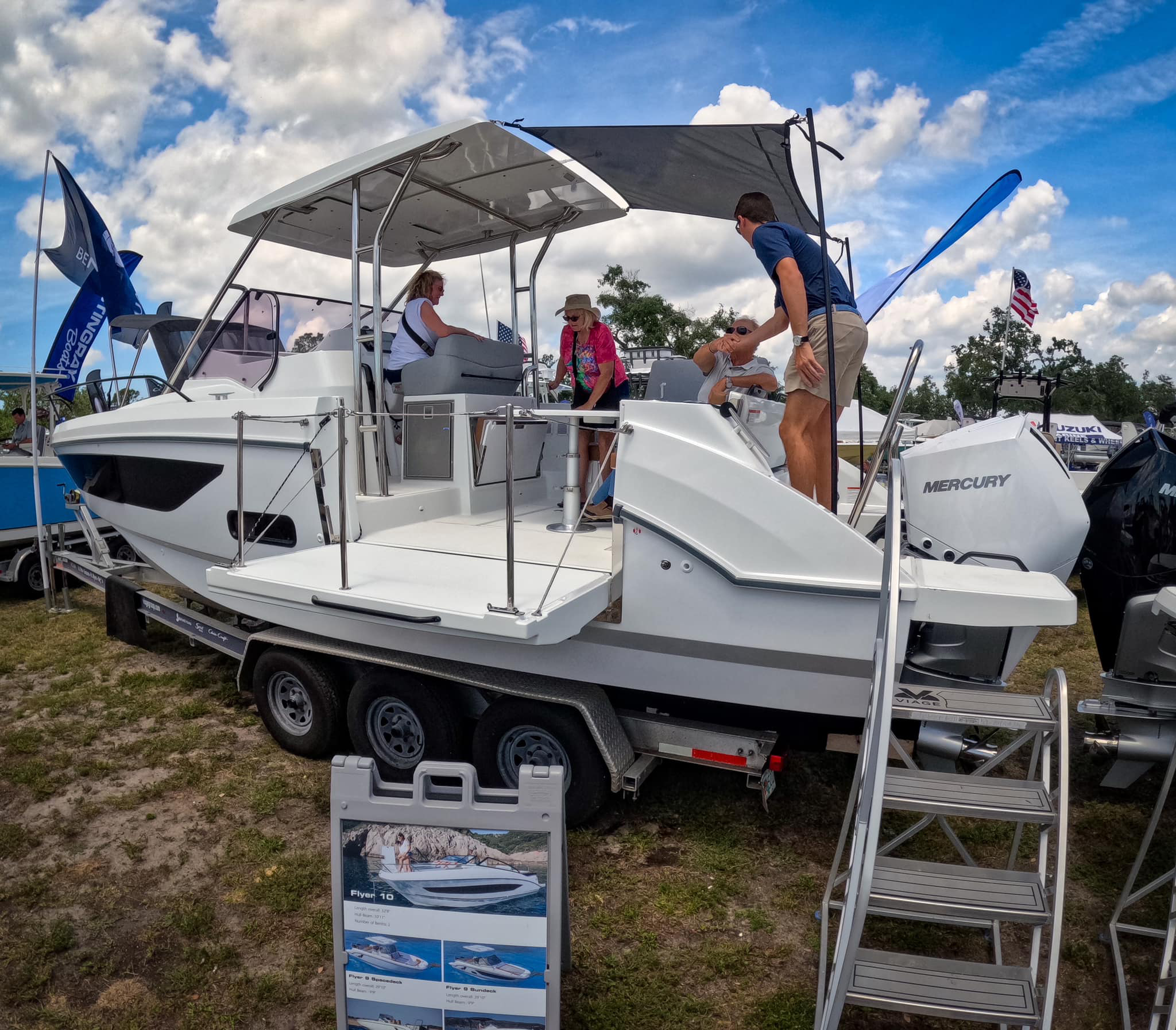 Photo of people looking at a boat for sale